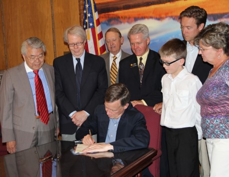 Colorado Governor John Hickenlooper signs Senate Bill 14-211 into law on June 5, 2014